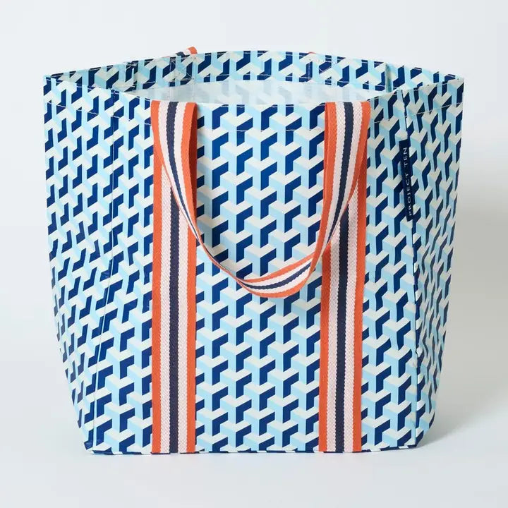 A blue shopper tote with orange stripe handles on a white background 