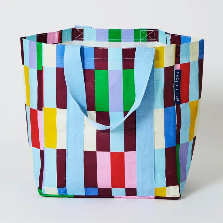 Colorful checkered tote bag with 'Project Ten' branding on a white background