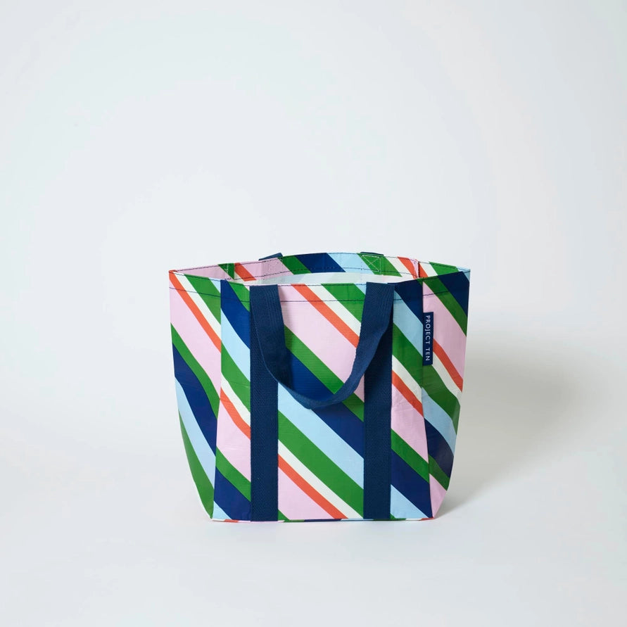 Colorful striped bag with handles on a white background