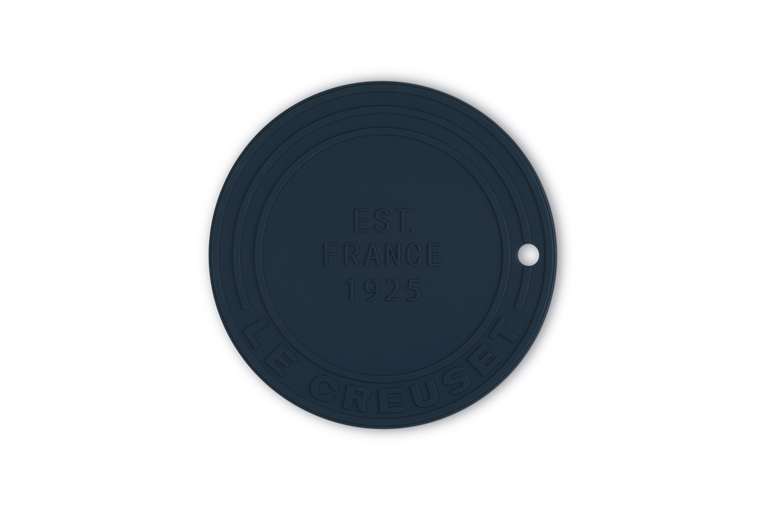 Navy blue silicone trivet with embossed text on a white background