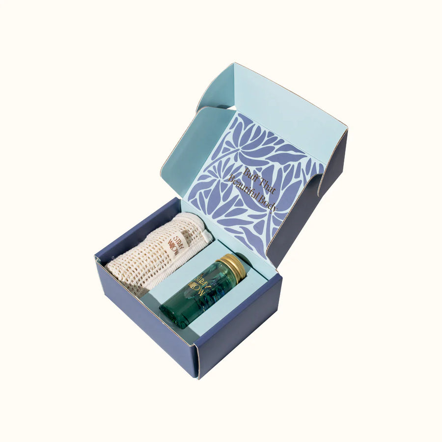 Gift set with a bottle and a cloth in a decorative box on a white background