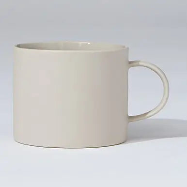 Beige ceramic mug on a light gray background
