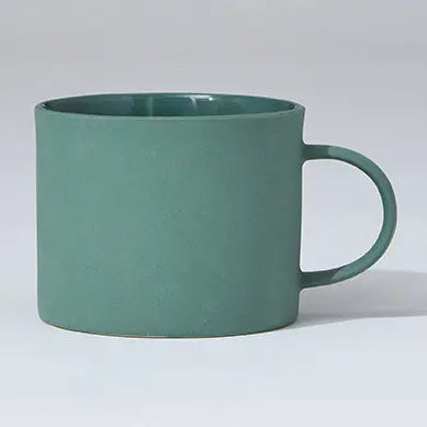 Green mug on a light gray background