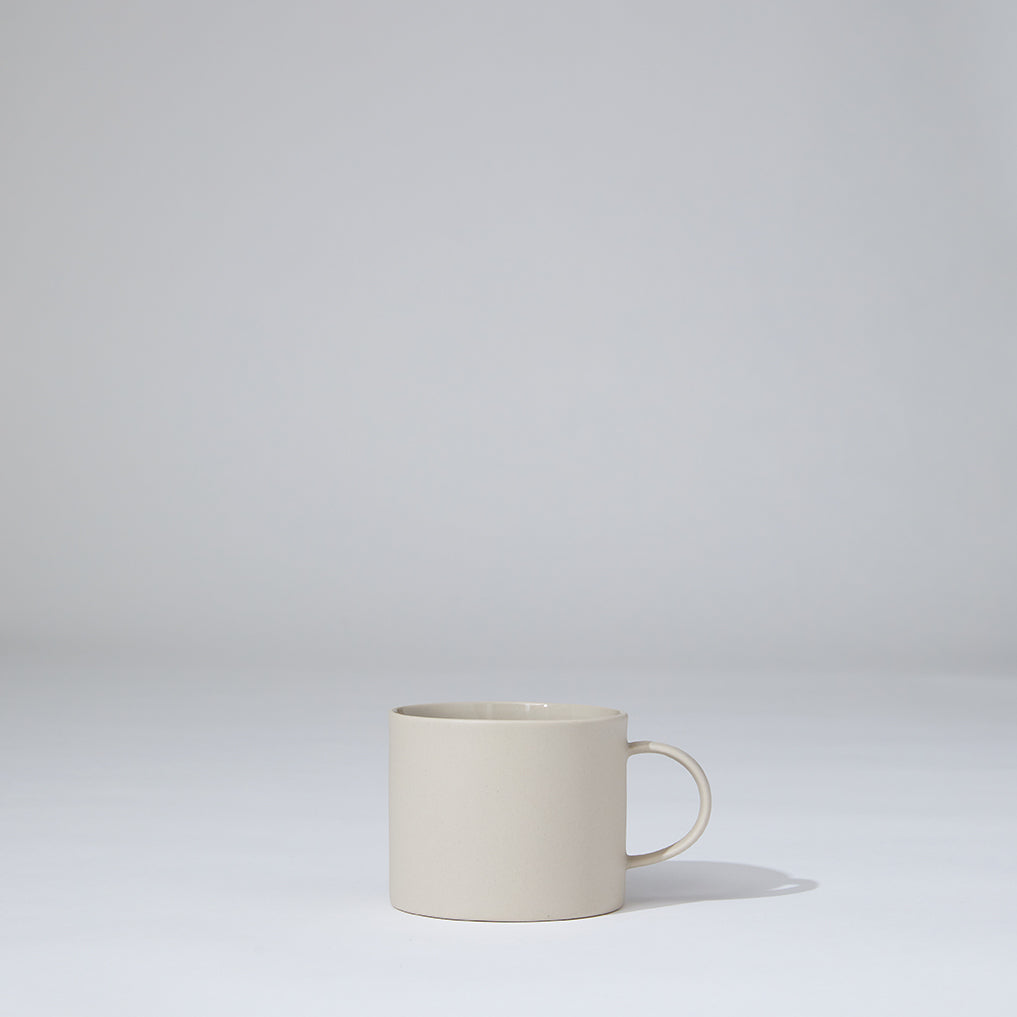 White ceramic mug on a light gray background