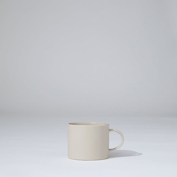 White ceramic mug on a light gray background