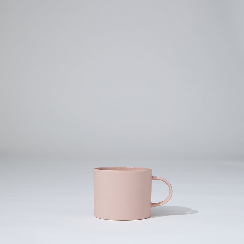 Pink mug on a light gray background