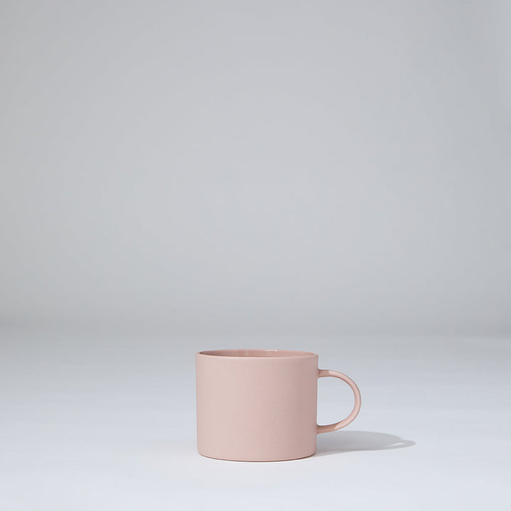 Pink mug on a light gray background