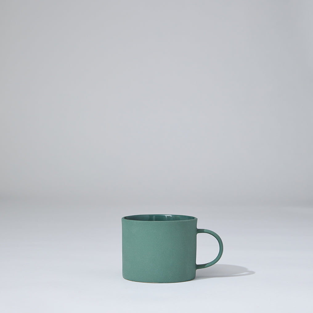Green mug on a light gray background