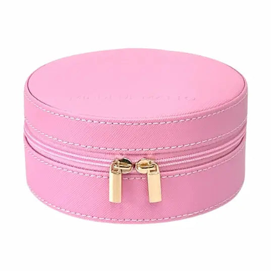 A pink faux leather round jewelry box with a double zipper closure and gold-tone pull tabs, shown on a plain white background.