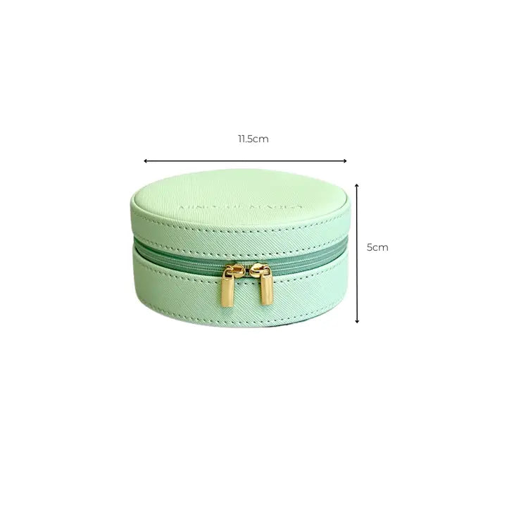 A mint green faux leather round jewelry box with a zippered closure and gold-tone hardware, shown with dimension lines indicating a width of 11.5cm and height of 5cm.