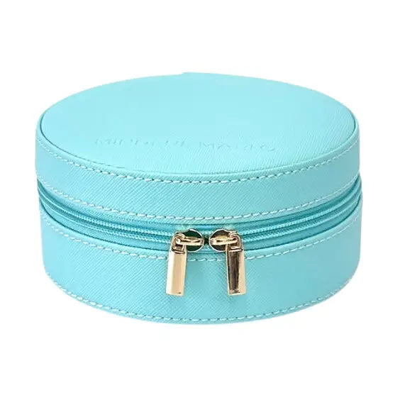 A light blue faux leather round zippered case with gold-tone zipper pulls, shown on a plain white background.