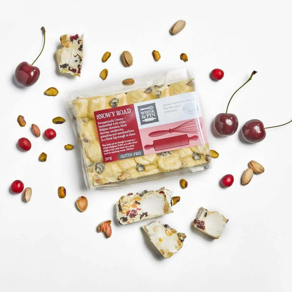 White chocolate rocky road with cherries, pistachios on white background