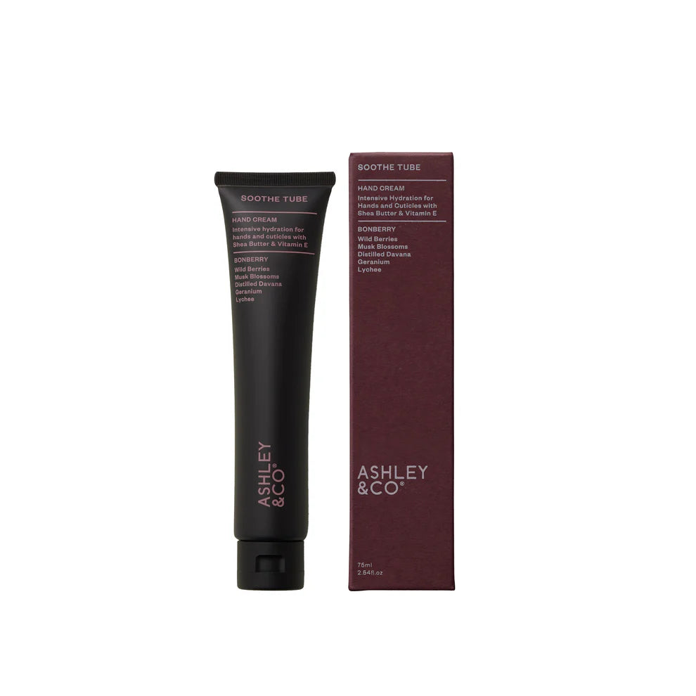 Black hand cream tube and maroon box with &