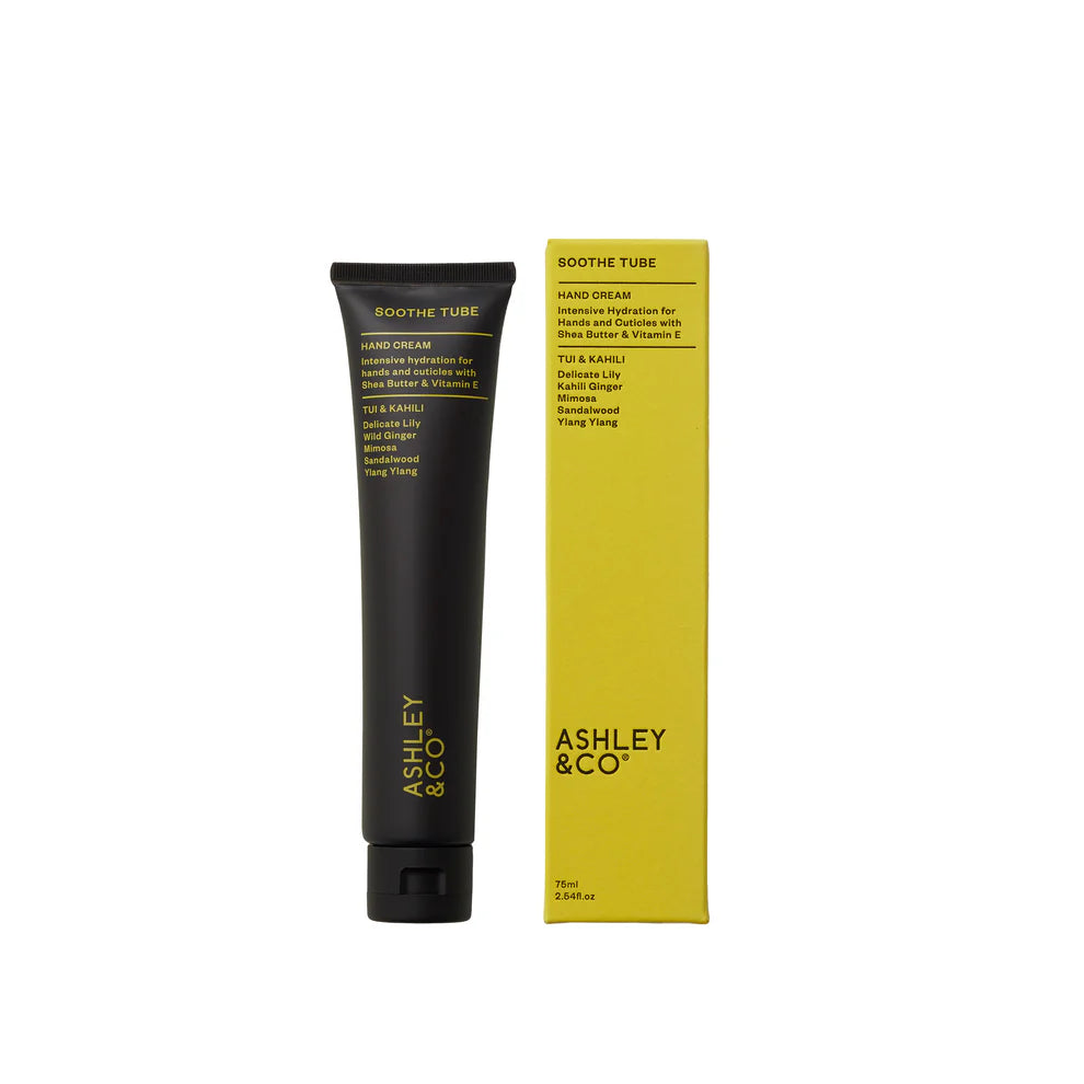 Black tube and yellow box of Ashley & Co hand cream on a white background