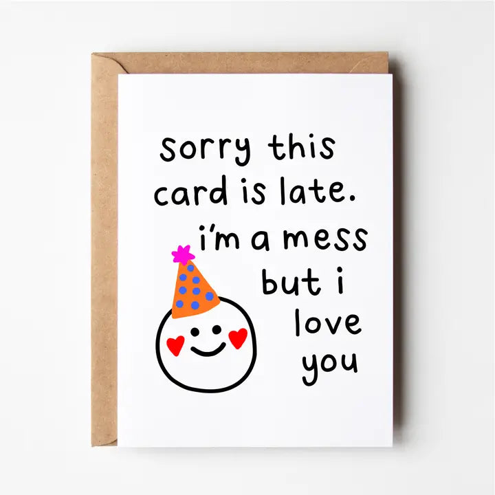 Card with text 'Sorry this card is late. I'm a mess but I love you' and a smiley face wearing a party hat on a white background.