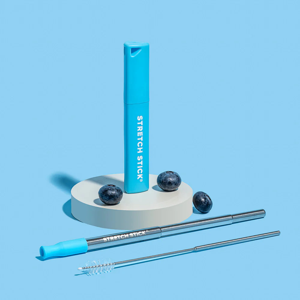 A Stretch Stick case with a stainless steel straw and cleaning brush on a blue background