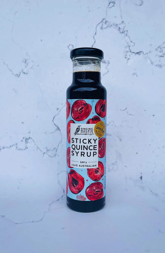 Bottle of Sticky Quince Syrup on a marble surface