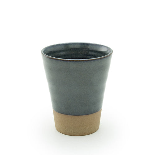 Ceramic cup with two-tone design on a white background