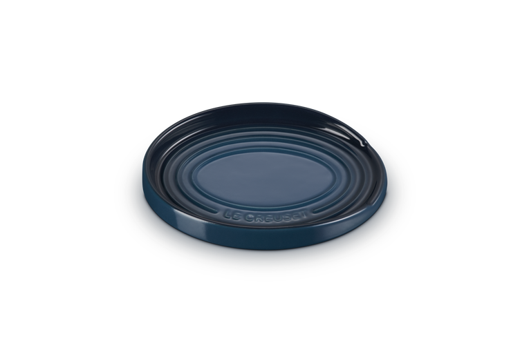 Blue ceramic spoon rest on a white background