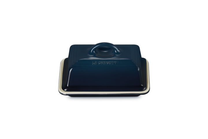 Dark blue ceramic butter dish with lid on a white background