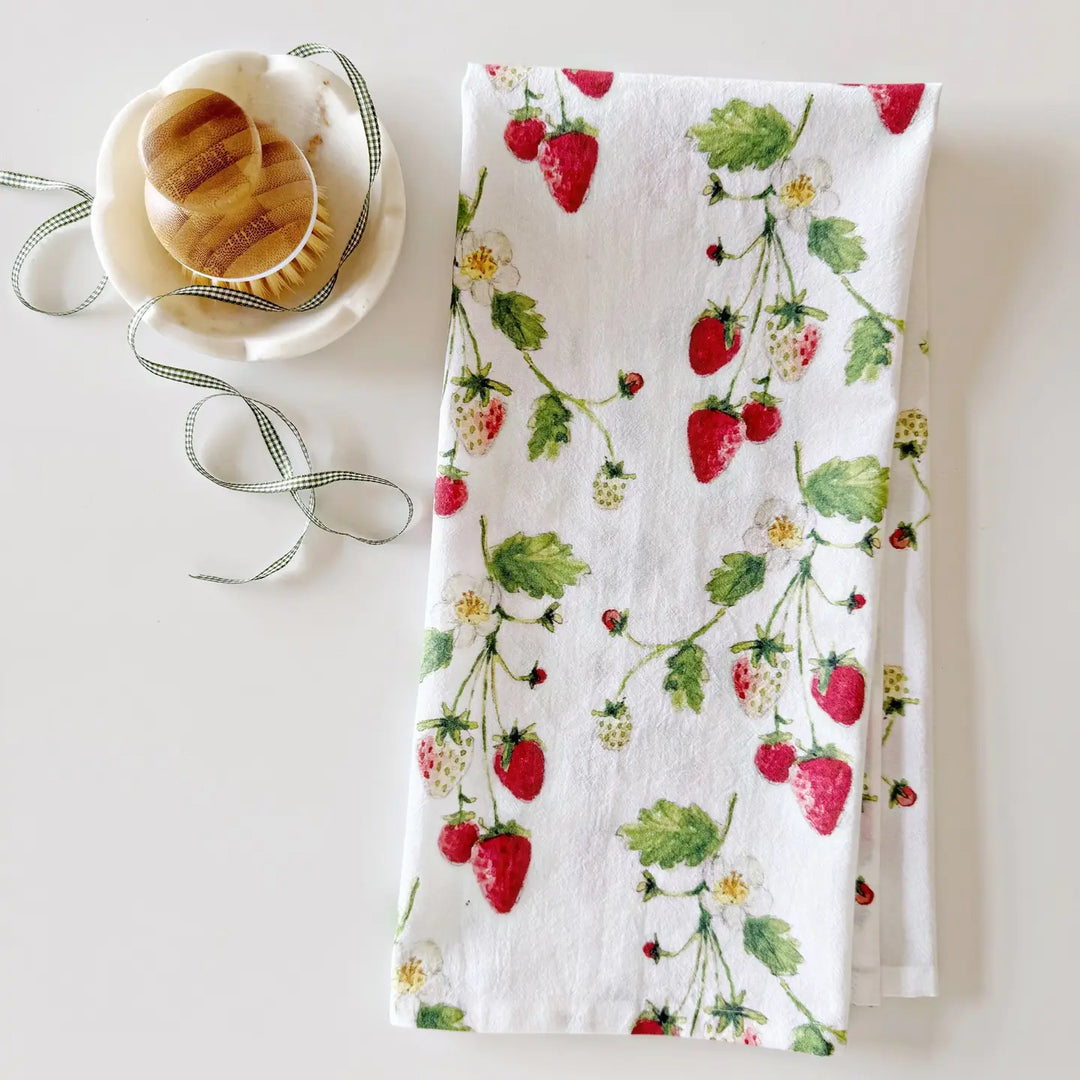 Tea towel with strawberry design on a white surface