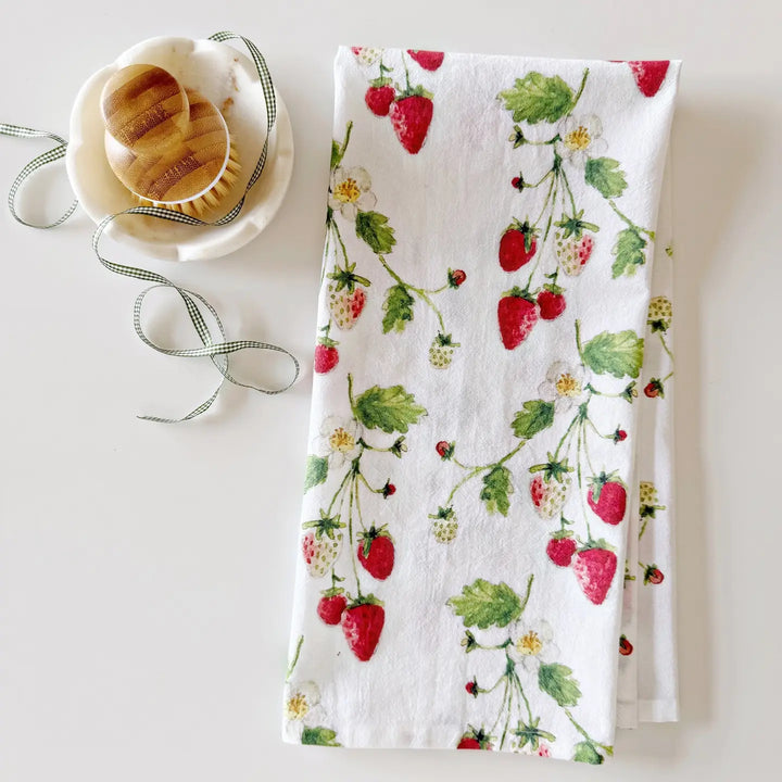 Tea towel with strawberry design on a white surface