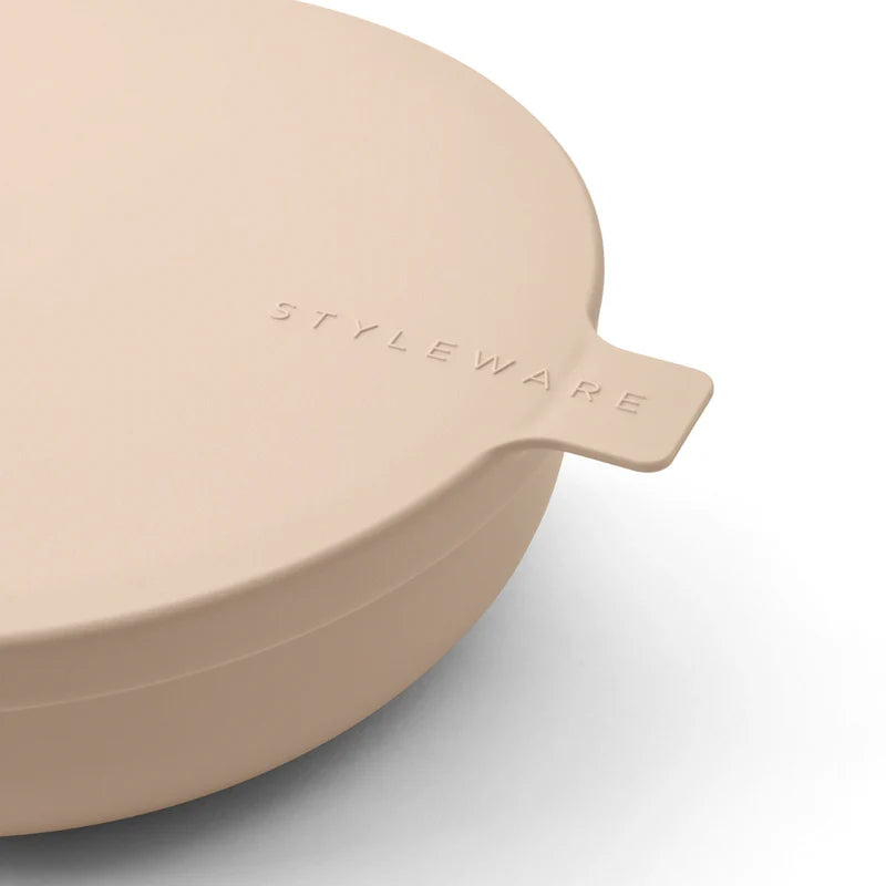Beige bowl with a lid featuring 'STYLEWARE' branding on a light gray background