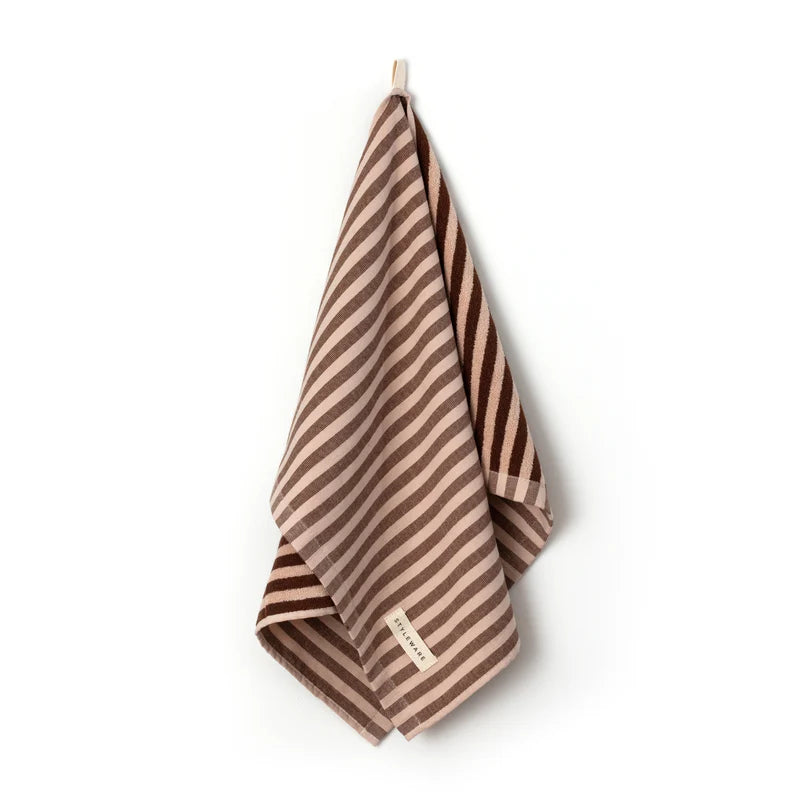 Striped tea towel with a brand label on a white background