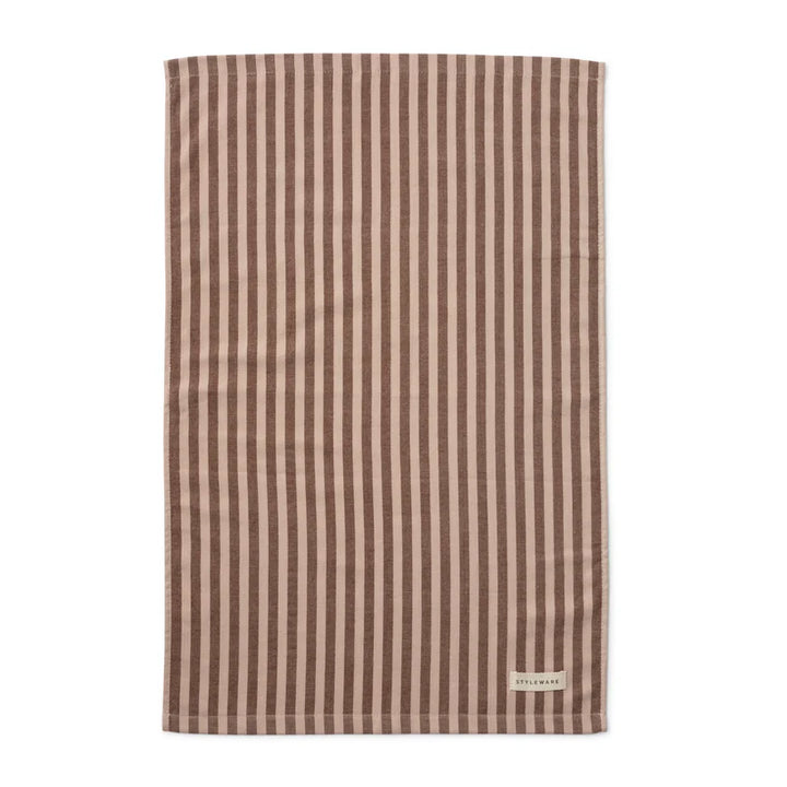 Striped tea towel with a brand label on a white background