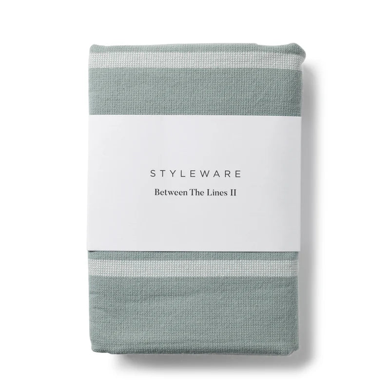 Folded tea towel with 'Styleware' branding on a white background