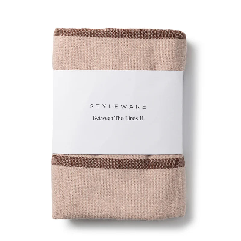 Folded tea towel with a white label displaying 'STYLEWARE' on a white background