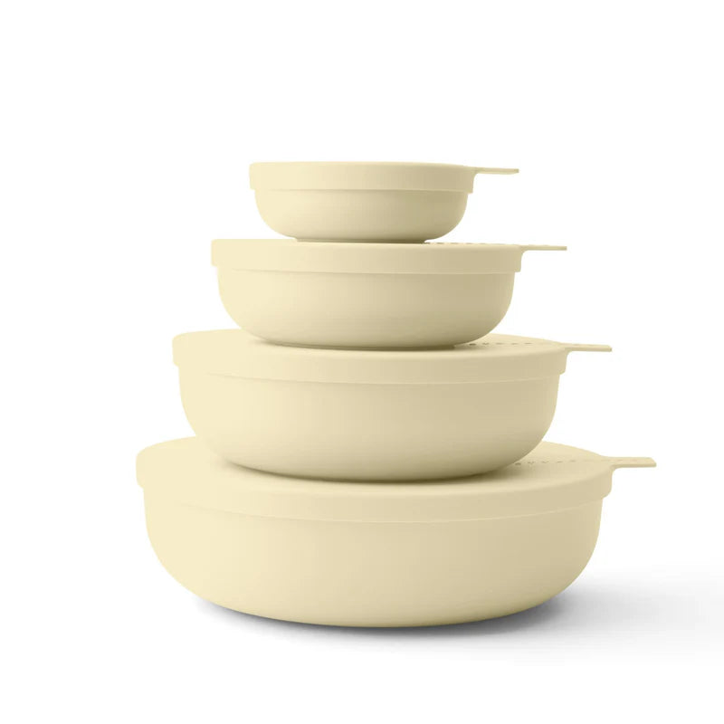 Set of five yellow-colored bowls stacked on a white background