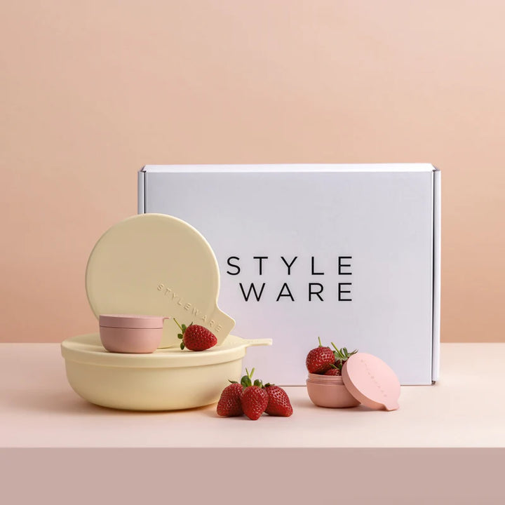Set of small bowls with a lid, strawberries, and a &