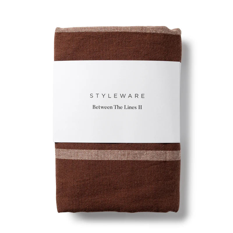 Folded brown tea towel with a white label featuring 'STYLEWARE' on a white background