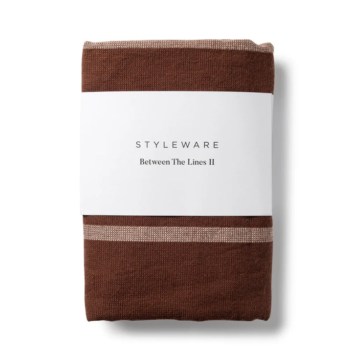 Folded brown tea towel with a white label featuring 'STYLEWARE' on a white background