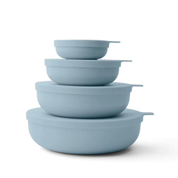 Set of four light blue nesting bowls on a white background
