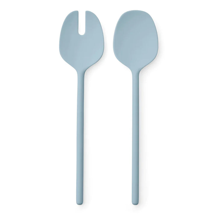 Two light blue salad servers on a white background