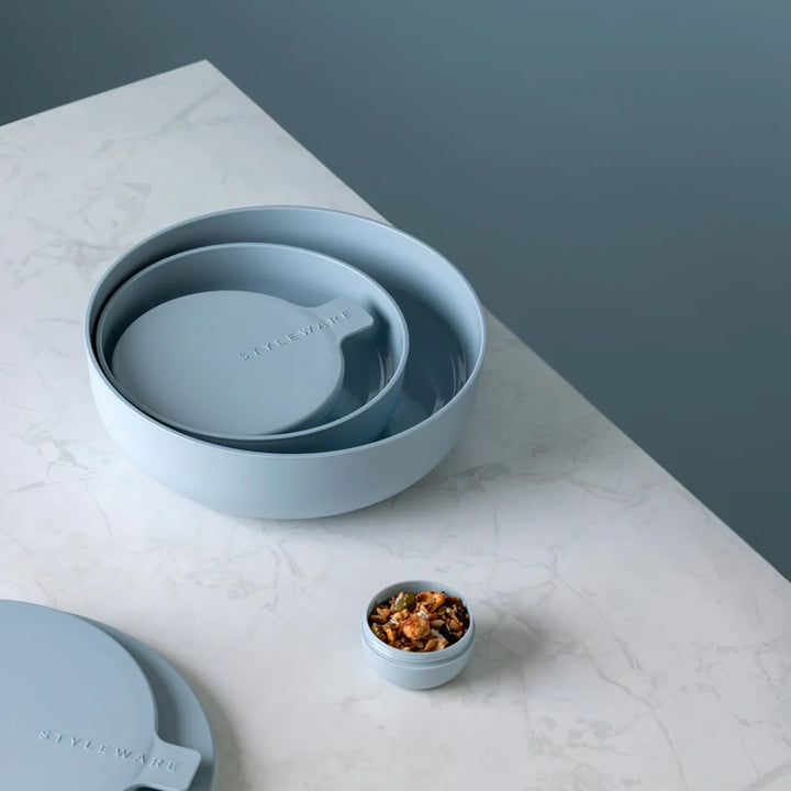Set of blue bowls on a marble surface with a neutral background
