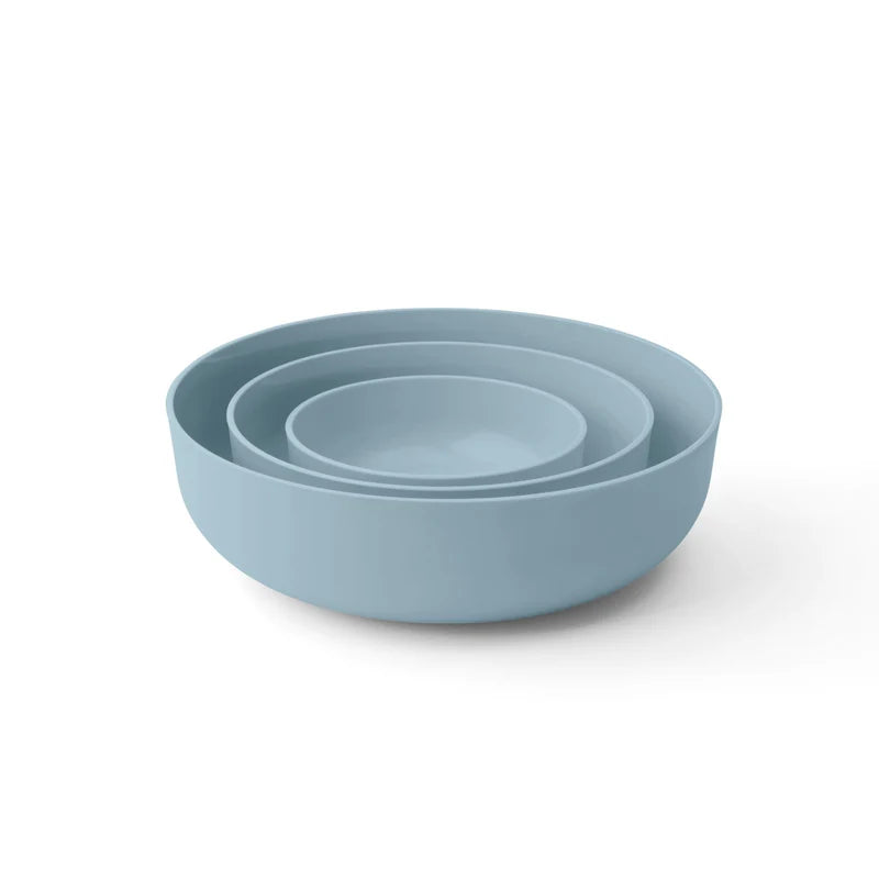 Set of three blue bowls on a white background