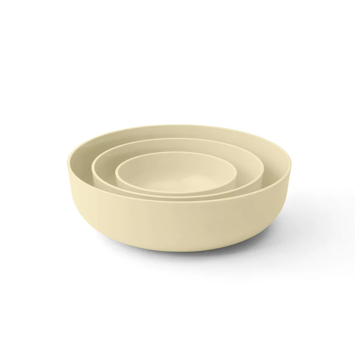 Set of three yellow bowls of different sizes on a white background