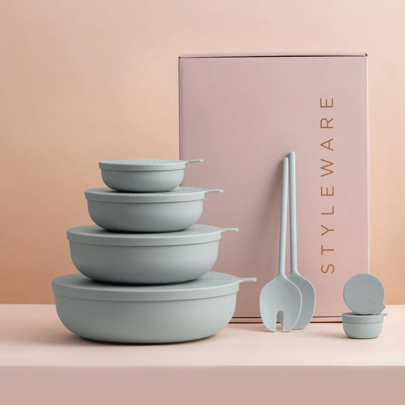Set of light green bowls and utensils with 'Styleware' branding on a pink background