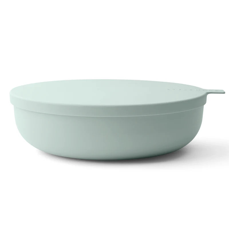 Light green bowl with lid on a white background