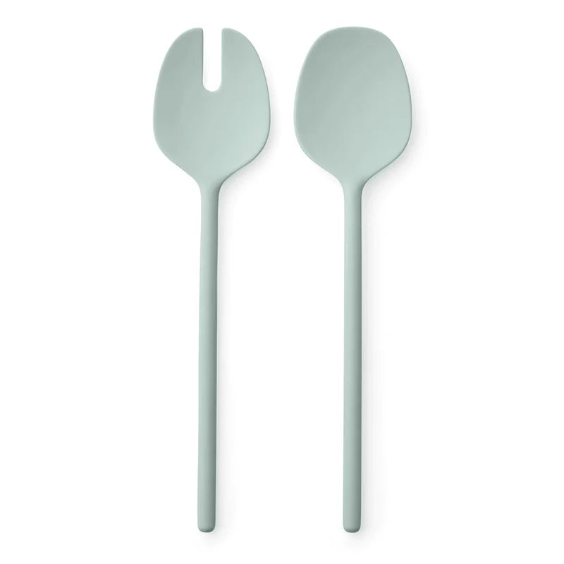 Two light green salad servers on a white background