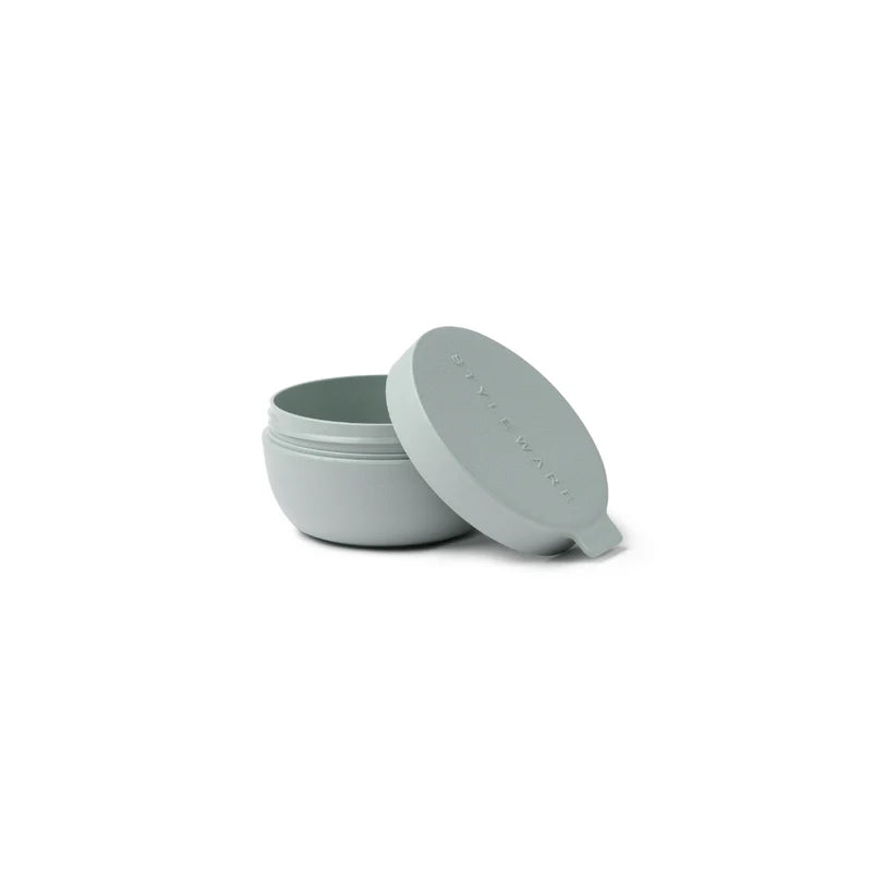 Light green plastic bowl with matching lid on a white background