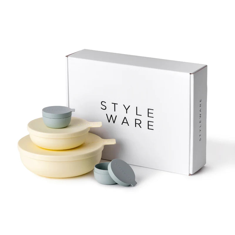 Set of bowls with lids in yellow & green next to a 'Styleware' box on a white background