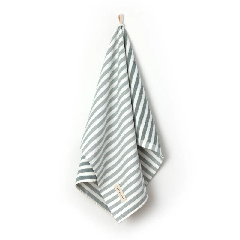 Striped tea towel with a brand label on a white background