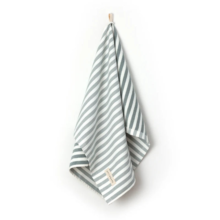 Striped tea towel with a brand label on a white background