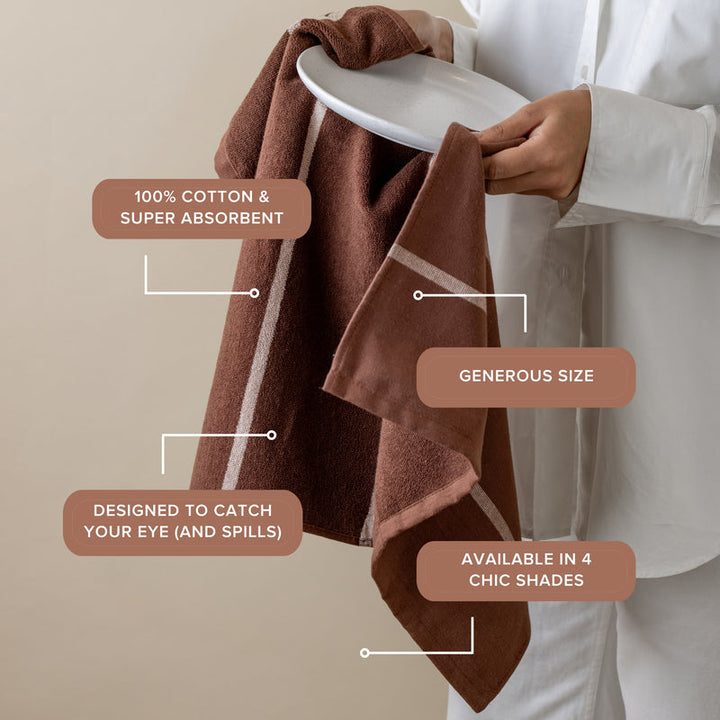 Brown towel held by a person with text highlighting features on a beige background