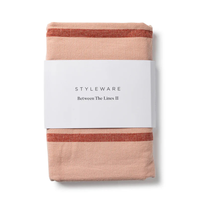 Packaged tea towel with 'Styleware' branding on a white background
