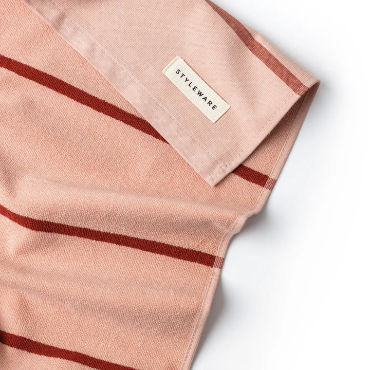 Pink fabric with red stripes and a 'STYLEWARE' label on a white background